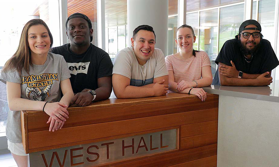 Five FSU students standing in front of West Hall sign