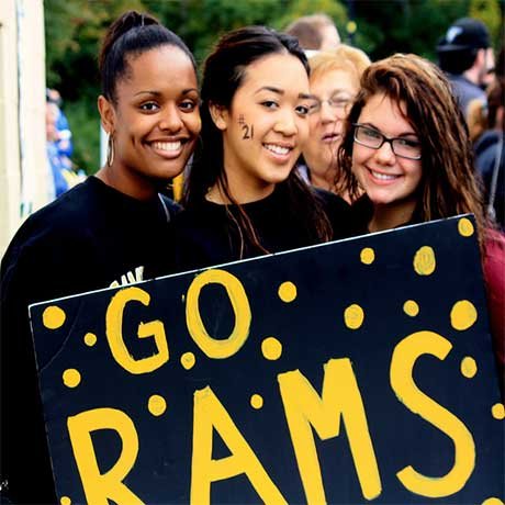 Students at Homecoming with a sign that reads "Go Rams"